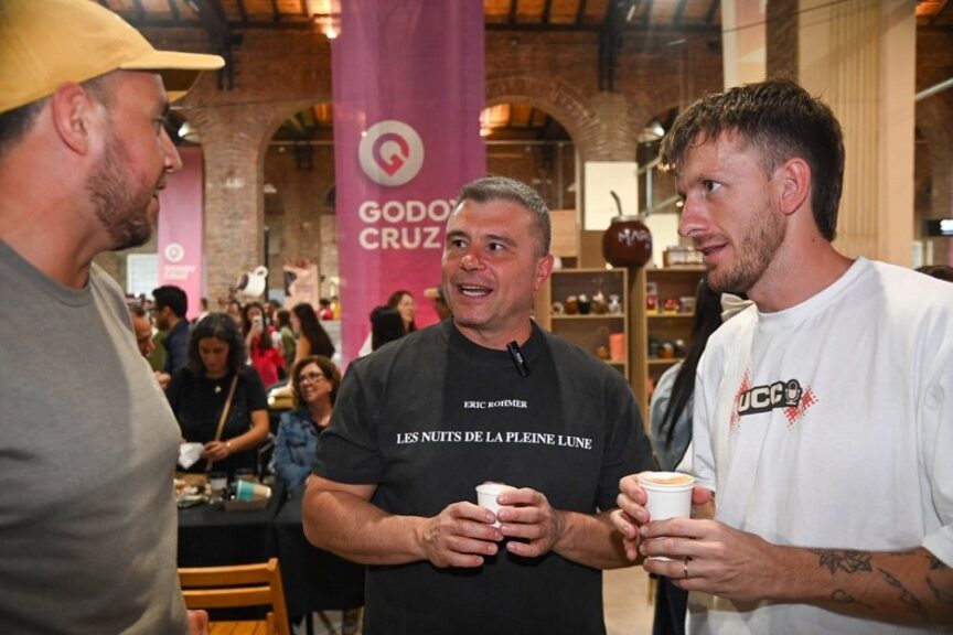 Visitantes conversando junto al banner de Godoy Cruz en el Mundial Mendocino de Café